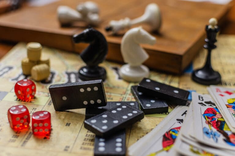Collection of Classic Tabletop Board Games on a Vintage Map — Le 1850, Le Sentier des Pins