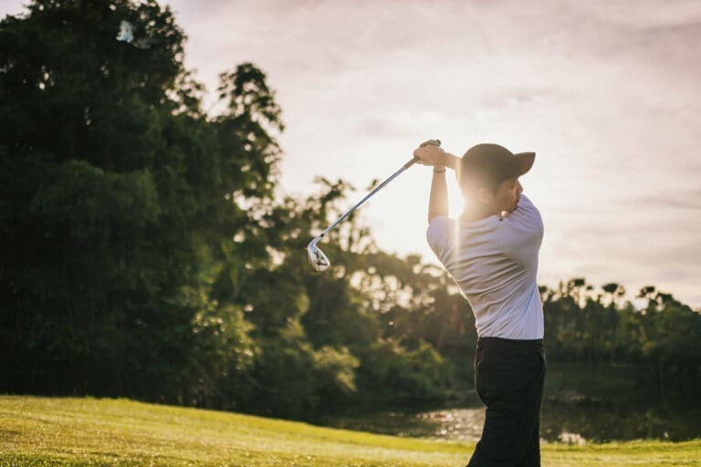 Golfer teeing off on a golf course – Domaine de Sainte-Croix